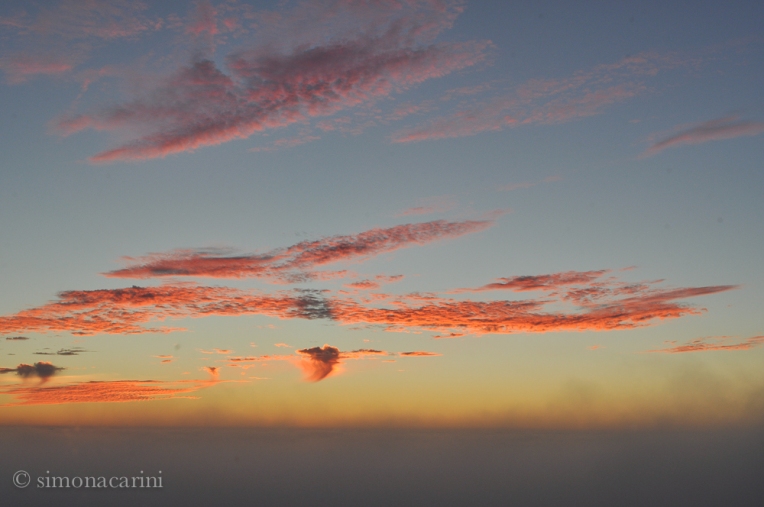 orange and pink clouds and fog after sunset